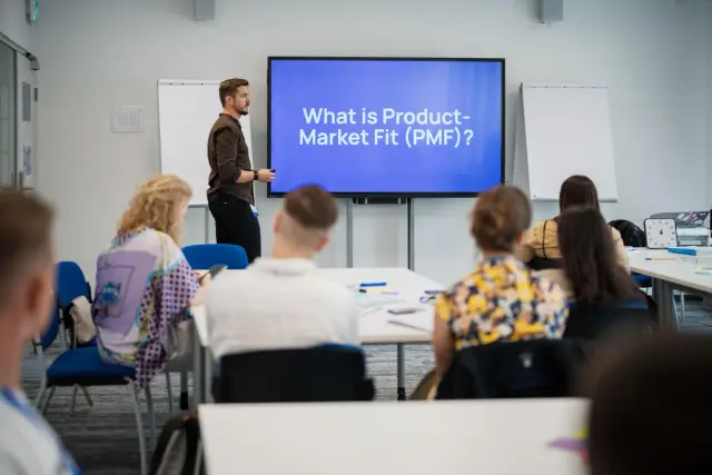Olek running a Product-Market Fit workshop in front of a class